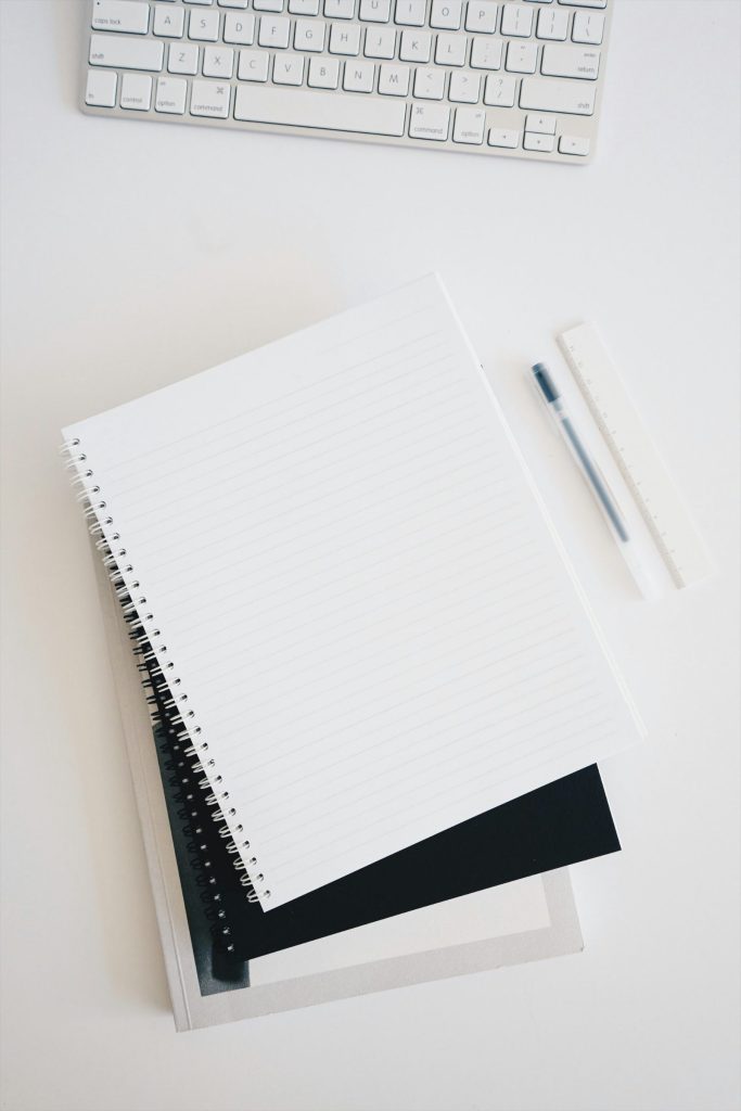 Notebook and pen representing writing a personal statement for a UK university application